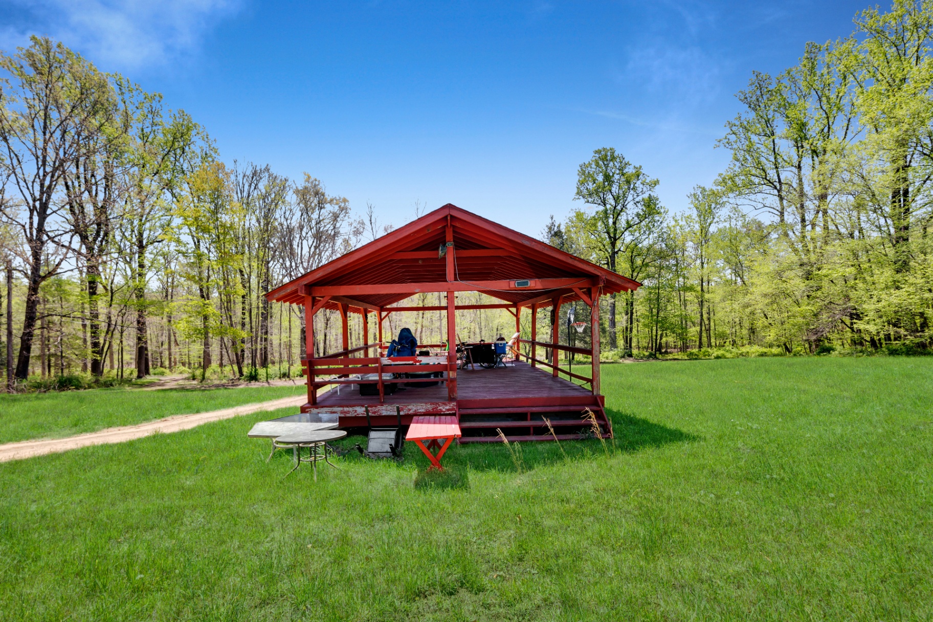 Red open-air pavilion stage in the field
